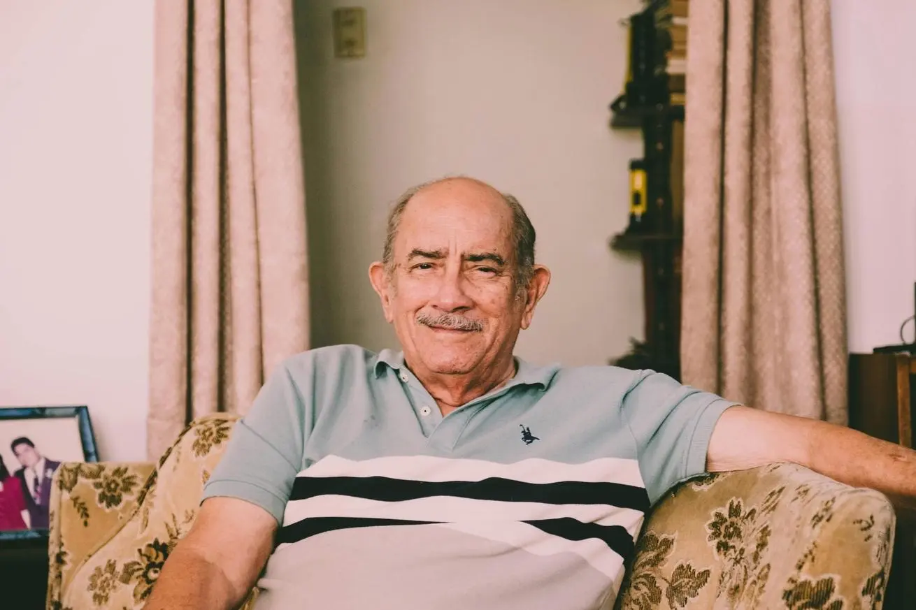 Grandfather sitting in a chair smiling