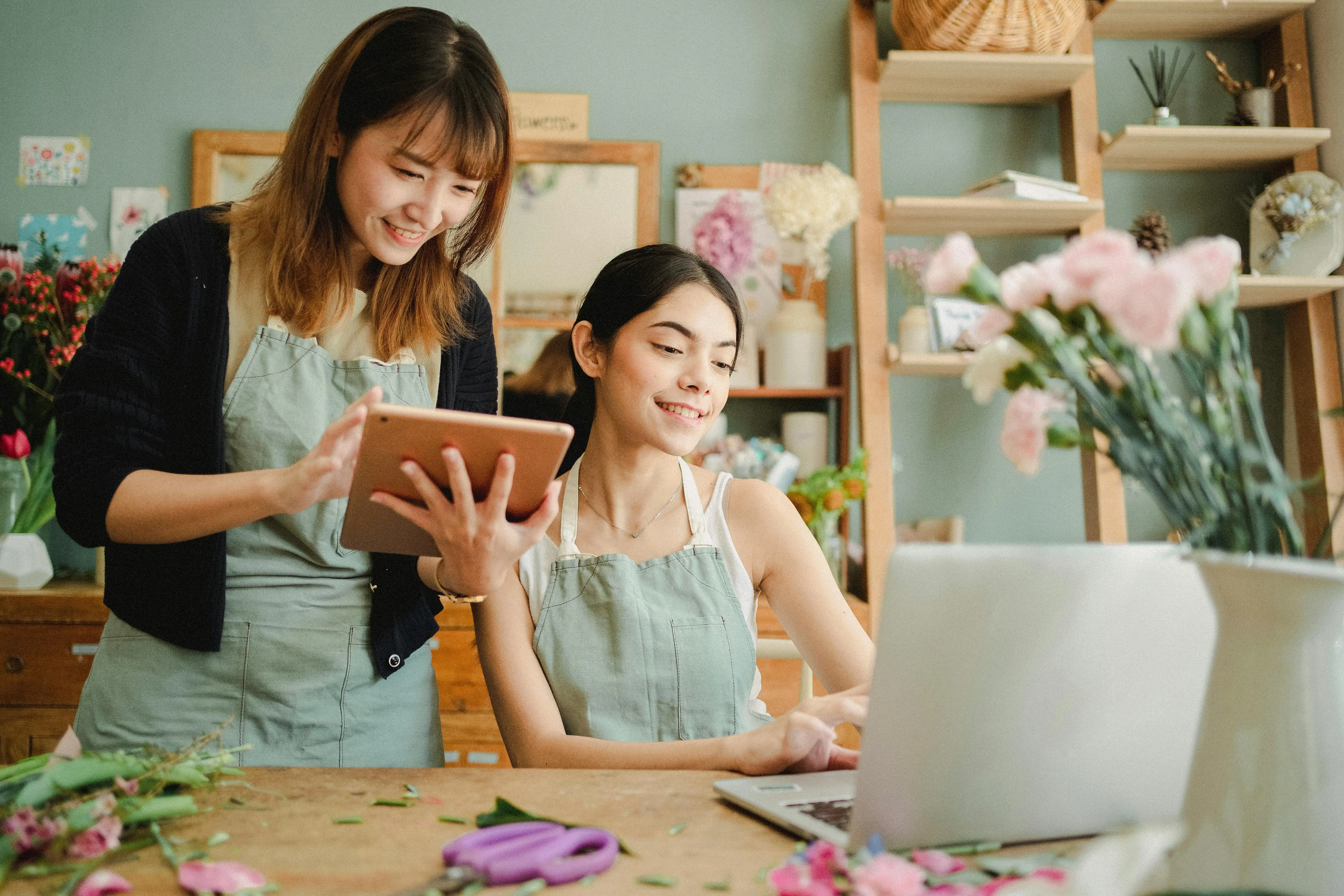 Two women working at a laptop at a boutique