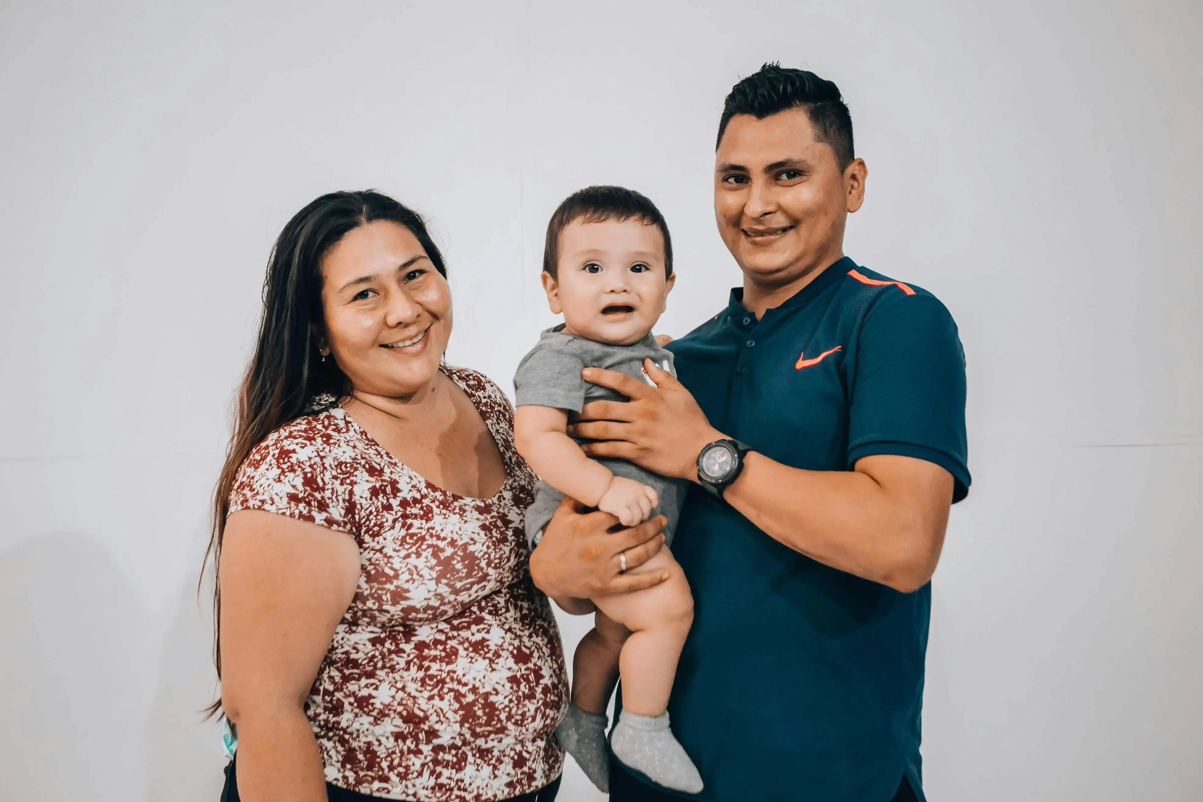 Family of three posing for a photo